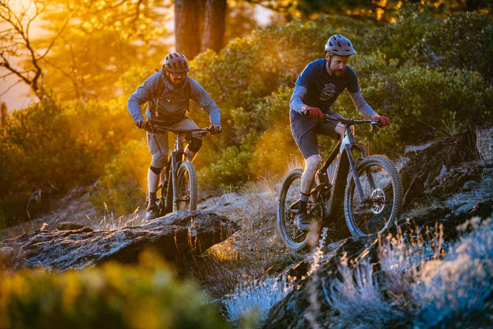 Mountain bikers riding the Santa Cruz Heckler bike